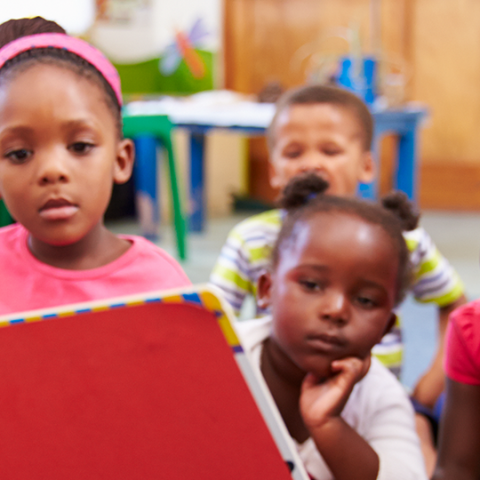 Male teacher reading to children