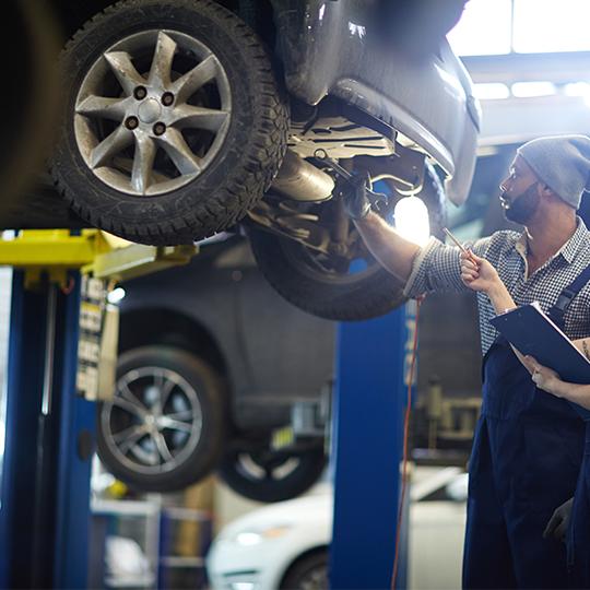 Auto Mechanics performing services in autoshop