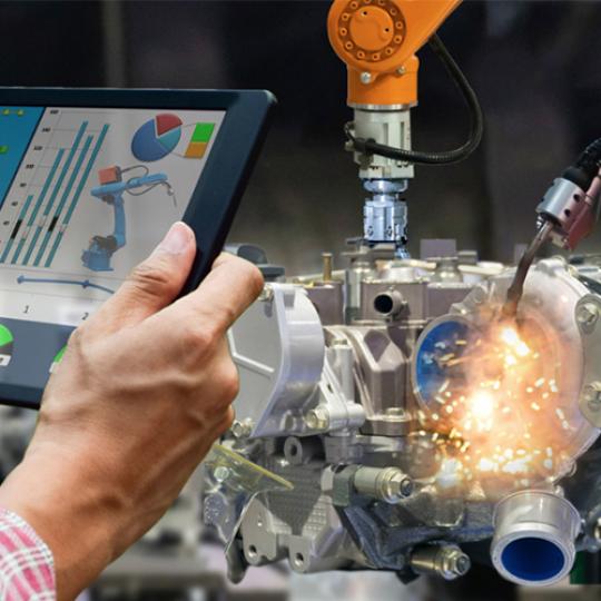 Engineer touch screen control robot the production of factory parts engine manufacturing industry robots and mechanical arm