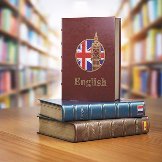 Learn English concept. English dictionary book or textbok with flag of Great Britain and Big ben tower on the cove in the library