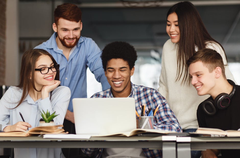 multiracial students working on school project together